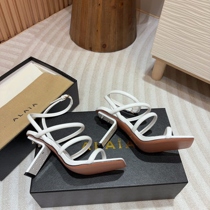 ALAIA THREE-STRAPS HIGH HEEL SANDALS IN WHITE PATENT LAMBSKIN