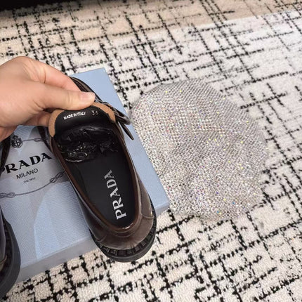 PRADA 26S BUCKLED LOAFERS IN DARK BROWN SHINY CALFSKIN