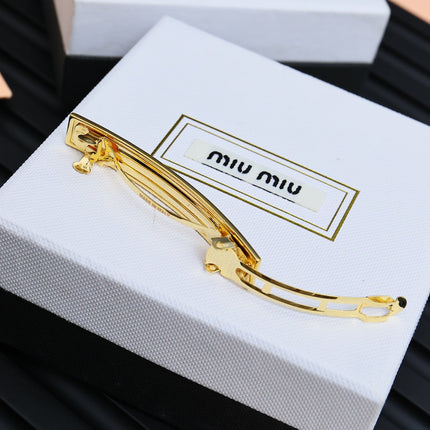 MIUMIU 26S LOGO BAR HAIR CLIP IN BLACK ENAMEL AND GOLD TONE METAL 612610